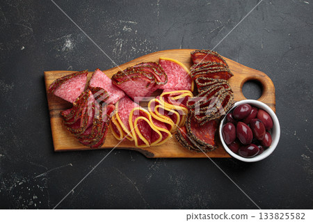 Charcuterie platter meat sliced salami pepperoni olives snack appetizer wooden board antipasto Charcuterie platter meat sliced salami pepperoni olives snack appetizer wooden board antipasto 133825582