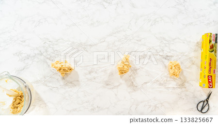 Dough divided onto cling wrap, ready to chill for Easter Cookie Sandwich with Raspberry Buttercream. Perfect for food preparation visuals and baking instruction content. Dough divided onto cling wrap, ready to chill for Easter Cookie Sandwich with Raspberry Buttercream. Perfect for food preparation visuals and baking instruction content. 133825667