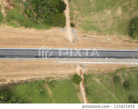 Newly constructed road connects rural areas with green fields Newly constructed road connects rural areas with green fields 133825858