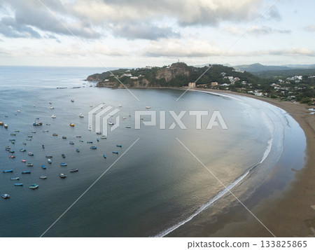 Beautiful shoreline with fishing boats in scenic coastal village Beautiful shoreline with fishing boats in scenic coastal village 133825865