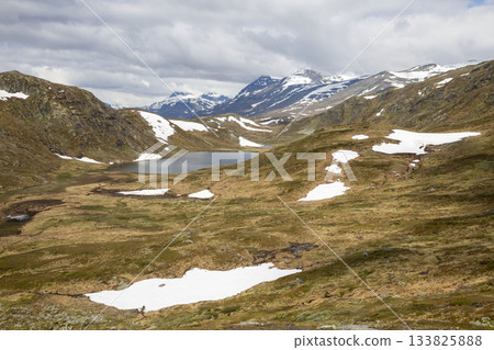 Stunning hike through Jotunheimen National Park from Bygdin mountain hotel to Synshorn mountain summit Stunning hike through Jotunheimen National Park from Bygdin mountain hotel to Synshorn mountain summit 133825888