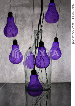 Still life with purple light bulbs and a glass jar 133825997