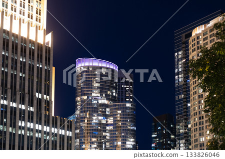 Night cityscape of Chicago skyscraper building. Chicago architecture of skyscraper. City night illuminated building. Skyscraper cityscape. Night city of Chicago. Business city. Quiet city night 133826046