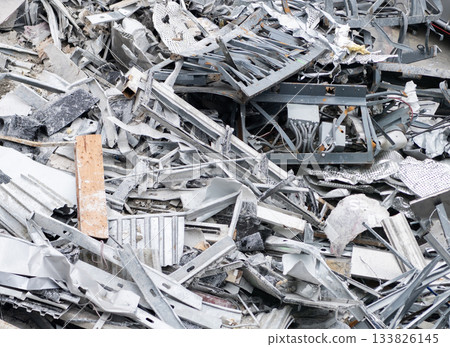 Aluminum scrap metal. Aluminum extrusion profile. Construction site storage with aluminum tubes. Steel extrusion. Industry material. Aluminum industry extrusion at building construction site Aluminum scrap metal. Aluminum extrusion profile. Construction site storage with aluminum tubes. Steel extrusion. Industry material. Aluminum industry extrusion at building construction site 133826145