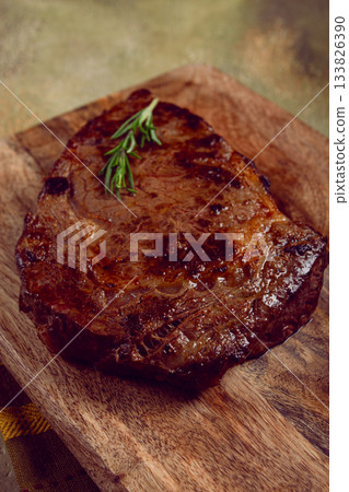 grilled steak, beef steak, rib eye steak, on a chopping board, top view, no people 133826390