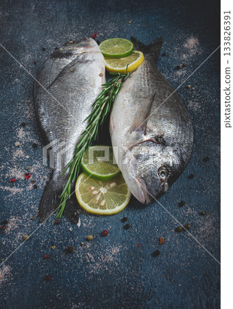 fresh, raw dorado fish, on a dark blue background, top view, two pieces, no people, fresh, raw dorado fish, on a dark blue background, top view, two pieces, no people, 133826391