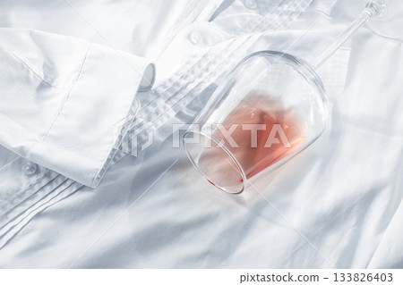 Glass, with pink wine, spilled on a white shirt, close-up, selective focus, no people, concept, top view, 133826403