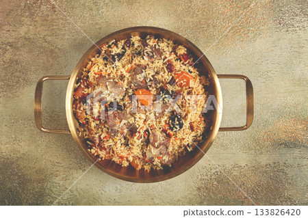 rice dish with meat and dried fruits, in a large pot, pilaf, homemade, no people 133826420