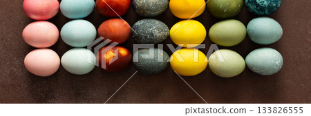 Brightly colored Easter eggs are arranged in a grid, displaying shades like pink, blue, green, and yellow. These eggs symbolize renewal and are often part of festive gatherings, banner Brightly colored Easter eggs are arranged in a grid, displaying shades like pink, blue, green, and yellow. These eggs symbolize renewal and are often part of festive gatherings, banner 133826555