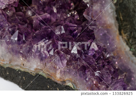 Amethyst Crystal Druse macro mineral on white background Amethyst Crystal Druse macro mineral on white background 133826925