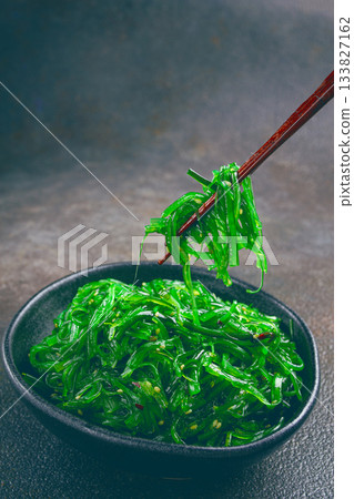 Chuka salad, made from fresh seaweed, with sesame dressing, served in a black bowl, with chopsticks, Chuka salad, made from fresh seaweed, with sesame dressing, served in a black bowl, with chopsticks, 133827162