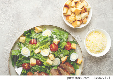 Caesar salad, with duck breast, on a light plate, on a light background, homemade, no people, 133827171