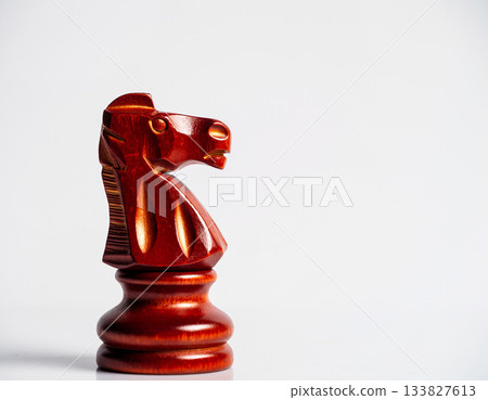 Close-up. Red chess horse on white background. Wooden symbol. Symbol of New Year. Happy new years. 133827613