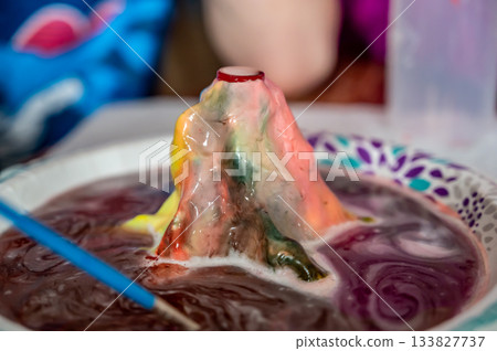 Home science experiment using baking soda and acid to form an eruption  133827737