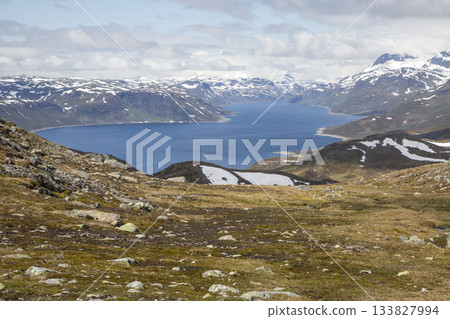 Scenic view of Lake Bygdin in Jotunheimen National Park showcases nature's beauty during summer 133827994