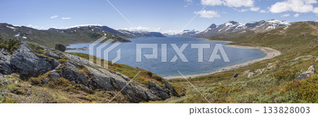 Exploring the serene shores of Lake Bygdin in Jotunheimen National Park on a sunny afternoon Exploring the serene shores of Lake Bygdin in Jotunheimen National Park on a sunny afternoon 133828003