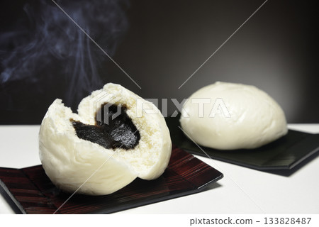 Steaming the bean buns in a steamer basket with rising steam Steaming the bean buns in a steamer basket with rising steam 133828487