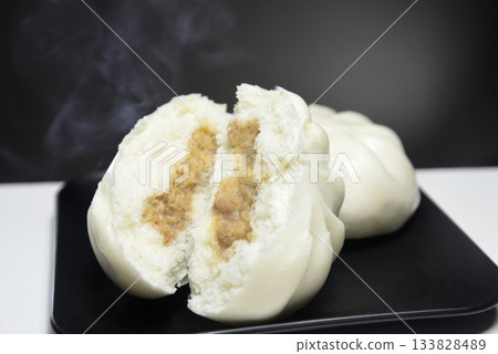 Steaming meat buns in a steamer with rising steam 133828489