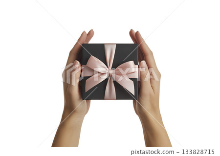 Pair of hands carefully presenting elegant black gift box tied with soft pink satin ribbon, symbolizing thoughtful present Pair of hands carefully presenting elegant black gift box tied with soft pink satin ribbon, symbolizing thoughtful present 133828715