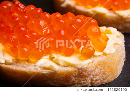 Sandwiches with red caviar. 133829190