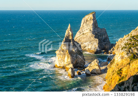 Sea Stacks near Cabo da Roca and Atlantic Ocean at Sunset. Portugal Sea Stacks near Cabo da Roca and Atlantic Ocean at Sunset. Portugal 133829198