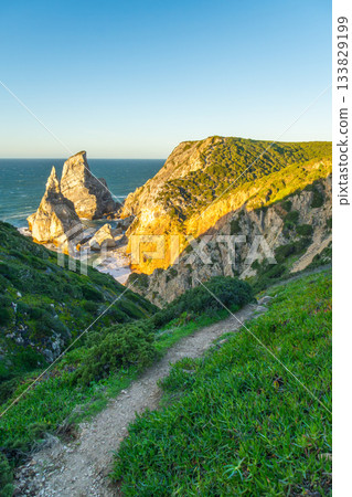 Cliffs of Cabo da Roca, Hiking Trail and Atlantic Ocean at Sunset. Portugal Cliffs of Cabo da Roca, Hiking Trail and Atlantic Ocean at Sunset. Portugal 133829199