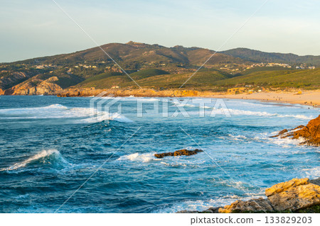 Guincho Beach and Sintra Mountains at Sunset. Atlantic Ocean, Portugal Guincho Beach and Sintra Mountains at Sunset. Atlantic Ocean, Portugal 133829203