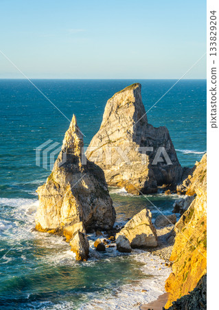 Sea Stacks near Cabo da Roca and Atlantic Ocean at Sunset. Portugal Sea Stacks near Cabo da Roca and Atlantic Ocean at Sunset. Portugal 133829204