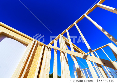 Construction of wooden beams structure under framing works day 133829350