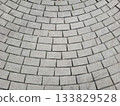 Gray sidewalk background, tiles laid in a curved, semi-circular pattern 133829528