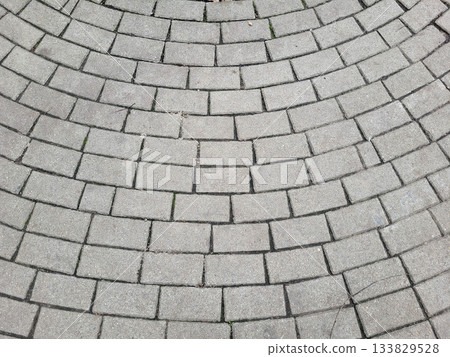 Gray sidewalk background, tiles laid in a curved, semi-circular pattern Gray sidewalk background, tiles laid in a curved, semi-circular pattern 133829528