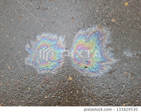 Bright multicolored spots on wet asphalt, top view Bright multicolored spots on wet asphalt, top view 133829530