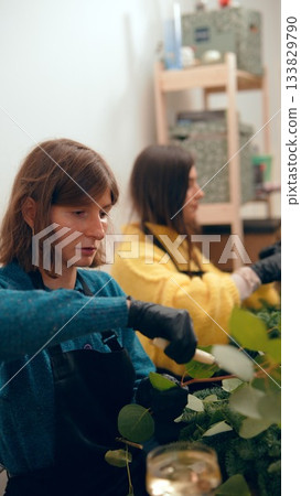 Teen engaging with botanical crafts amidst cozy workshop setting 133829790