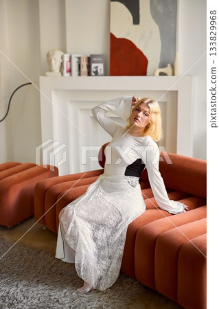 Chic model with poised expression against sophisticated interior 133829968