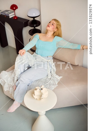 casual lady with comfortable surroundings, modern setting with woman in casual attire lounging peacefully 133829974