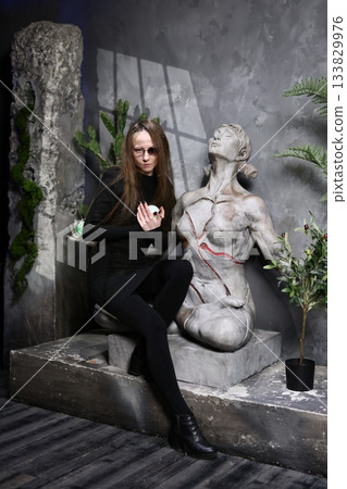 Indoor scene showcasing ritualistic movement and illuminated sculpture Indoor scene showcasing ritualistic movement and illuminated sculpture 133829976