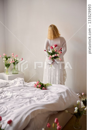 Fashionable blonde model with lace skirt and floral arrangement Fashionable blonde model with lace skirt and floral arrangement 133829993