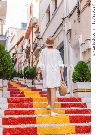 Young woman in a white dress walking up the colourful Spanish Steps in the Arrabal old town of Calpe, Spain Young woman in a white dress walking up the colourful Spanish Steps in the Arrabal old town of Calpe, Spain 133830187