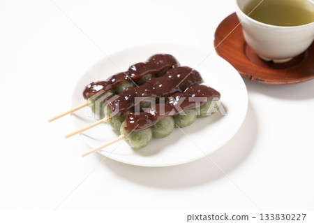 Mugwort skewers and tea on a white plate 133830227