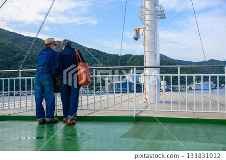 A couple looking at the view from the boat 133831012