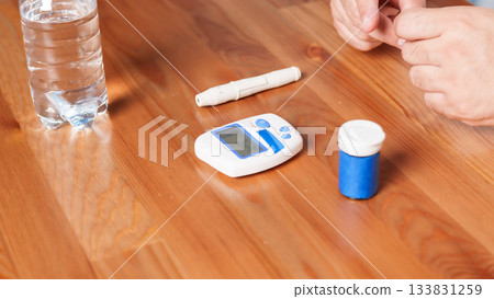 4K close-up of a glucometer lying on a table with diabetes testing accessories. Clean minimalistic setup, soft medical lighting, and a clear healthcare atmosphere. Concept of blood glucose monitoring 4K close-up of a glucometer lying on a table with diabetes testing accessories. Clean minimalistic setup, soft medical lighting, and a clear healthcare atmosphere. Concept of blood glucose monitoring 133831259