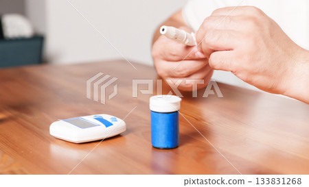 4K close-up of a glucometer lying on a table with diabetes testing accessories. Clean minimalistic setup, soft medical lighting, and a clear healthcare atmosphere. Concept of blood glucose monitoring 133831268