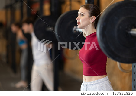 Woman with a barbell in the gym 133831829