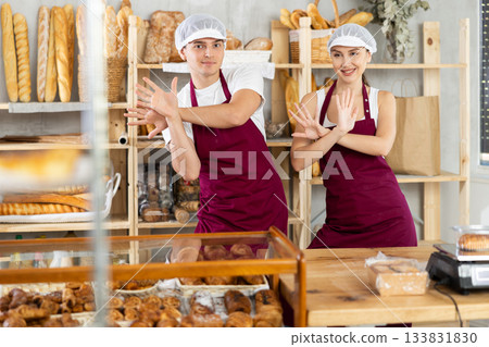 Woman and man sellers dance at counter in bakery Woman and man sellers dance at counter in bakery 133831830