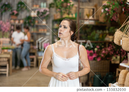 Female shopper choosing products in gardening supply store Female shopper choosing products in gardening supply store 133832030