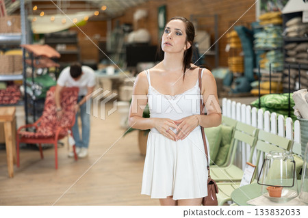 Female shopper choosing products in gardening supply store Female shopper choosing products in gardening supply store 133832033