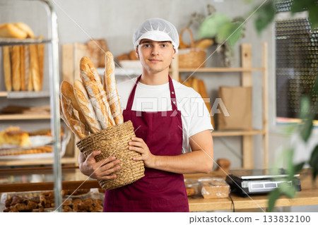 A male baker sells croissants, shows off a variety of crescent-shaped buns. A male baker sells croissants, shows off a variety of crescent-shaped buns. 133832100