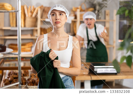 Young girl standing with her back to angry salesman pointing at the door 133832108