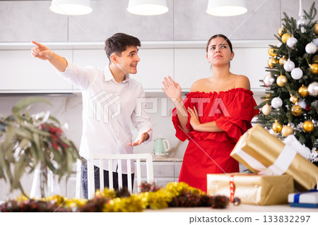 Couple quarreling - husband expresses displeasure to wife during new year celebration Couple quarreling - husband expresses displeasure to wife during new year celebration 133832297