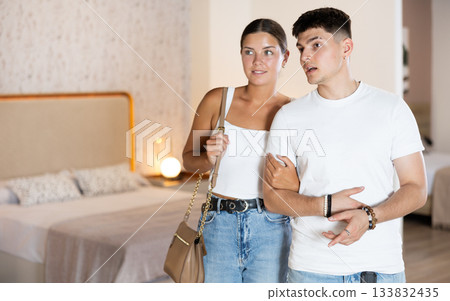 Couple man and woman looking around in bedroom department 133832435